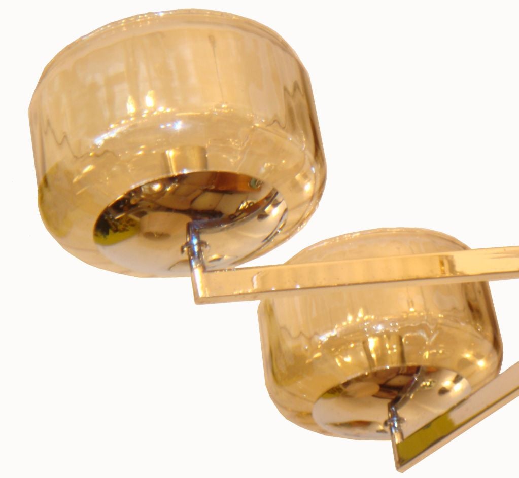 Polished chrome modernist chandelier.
Original  shades.
Adjustable height,
Wired for US and in working condition. 25W max bulb
Pair Available
