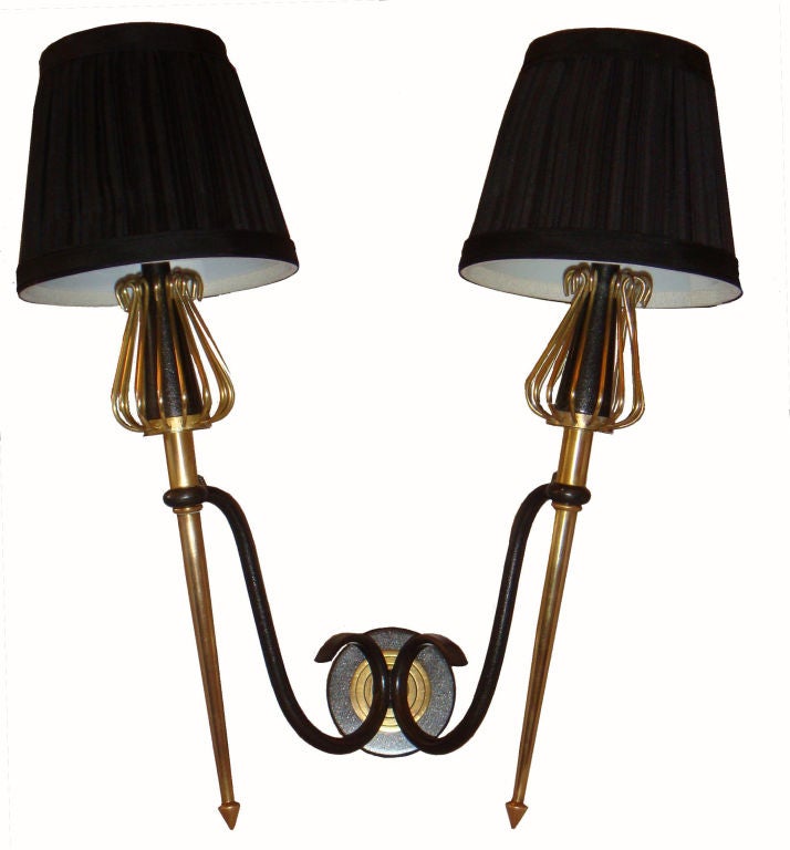 Very unique,  4 Pairs available of Mid-Century Modern double Torch Sconces.
Two patinas Gun Metal and Brass, by Lunel Paris France.
4 pairs available.
US wired and in working condition.
Back plate 3.5 inches diameter.
Have a look on our largest
