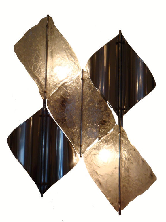 Dimensional and sculptural pair of Mazzega sconces.
Lozenges of polished steel and frozen glass.