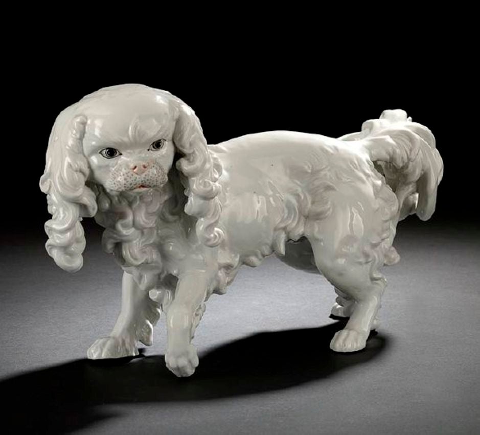 The blanc de chine figure of large size has eyes detailed in gray and black, the muzzle delicately detailed in pale gray, the nose and lower lip in the palest of pink, the underbelly with the entwined Potschappel 
