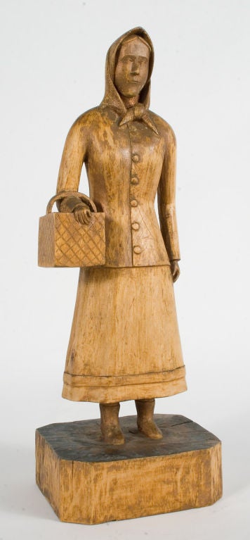 Wood Sculpture of a Woman carying a Basket.