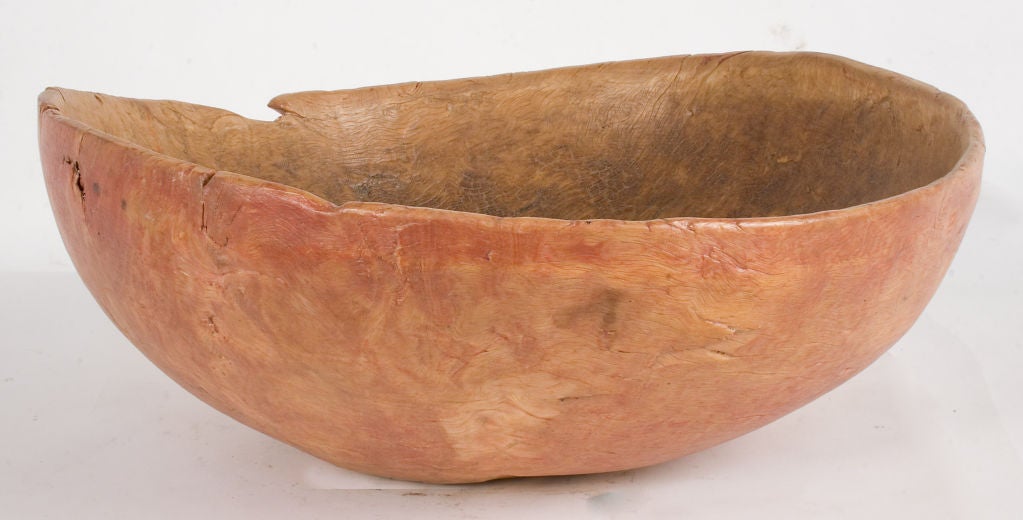 Large carved Wooden Bowl with a worn red patina.