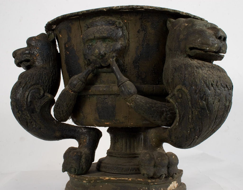 A Black Painted Royal Urn from Sweden with carved Gargoyles in wood.