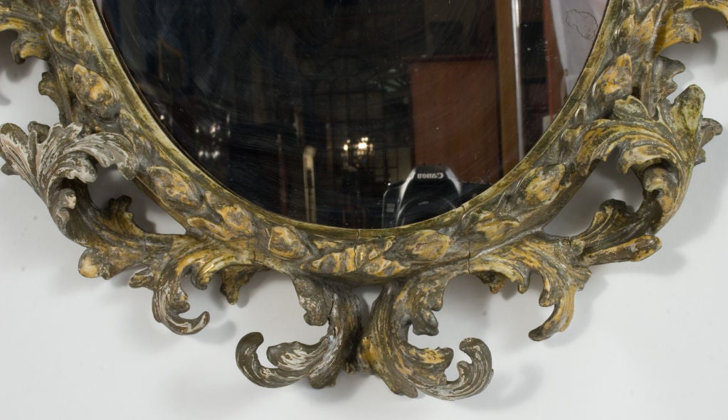 Pair of ornately carved Rococo Mirrors in a wreath motif.