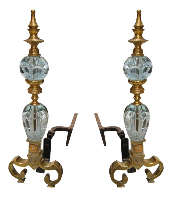These beautiful controlled bubble and brass andirons are simply exquisite. The glass sections are a pale Tiffany blue.The base is made of solid brass and the wood holders are cast iron. The detail is amazing. These are one of a kind.<br />
<br