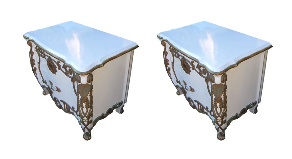These beautiful commodes are designed by the talented designer Ricardo Lynn and manufactured by Ricardo Lynn & Corporation. They date from the 1970s. The commodes feature a matte white finish with solid wood frame and a ornately carved gold accents