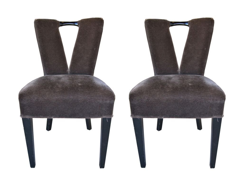 Pair Of Paul Laszlo corset chairs.

These chairs are upholstered in charcoal mohair fabric and are in excellent condition.

One of the chairs has a small hole in the fabric right on the seat, it is small and if you look up close it is