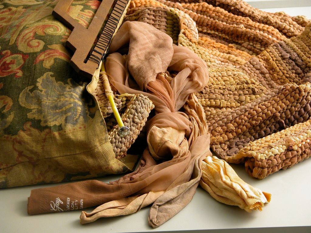 A knitting bag with the photographic portrait of its owner, containing. 

A rug decades long in the making yet unfinished woven entirely of her stockings and hosiery,

Nashville, Tennessee.

Custom mount.