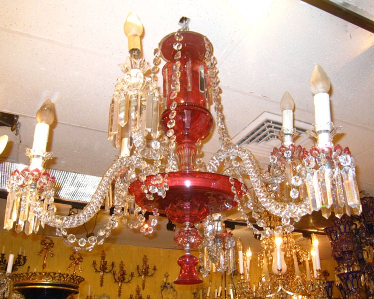 This ruby red and clear glass chandelier features two levels of candle arms and six total lights. It has modern wiring and is ready for installation. Possibly by Osler.
Stock number: L73.