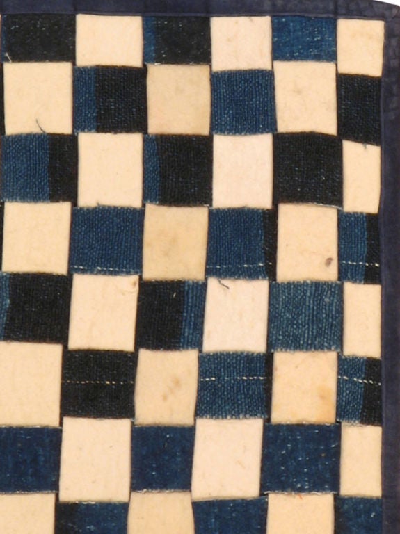 Una alfombra moderna construida con fieltro y material de tienda vintage.
