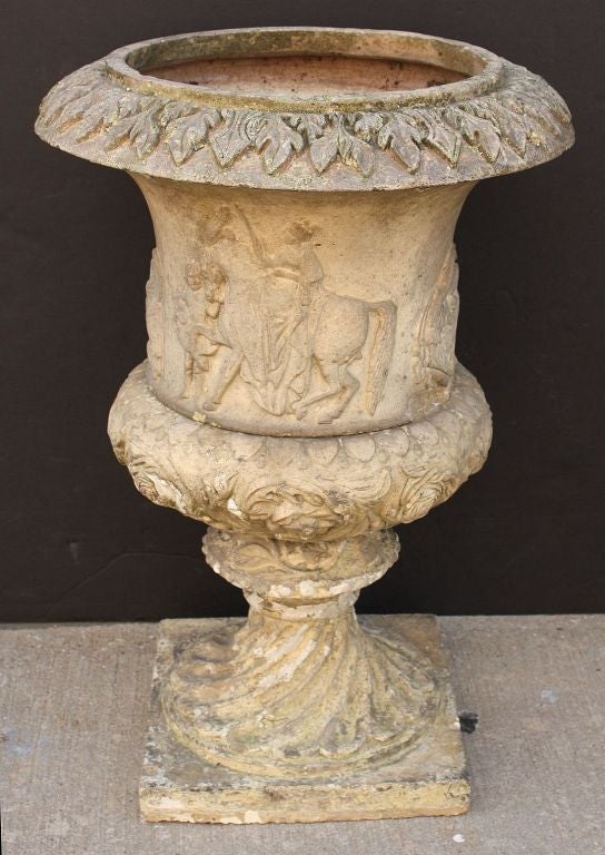 A fine Scottish garden urn of terra cotta (2 pcs.) featuring a figural relief design around the circumference and base. 

Showing ivy leaves around the rim, a king astride a horse with attending knave, a man with griffin, above clusters of roses