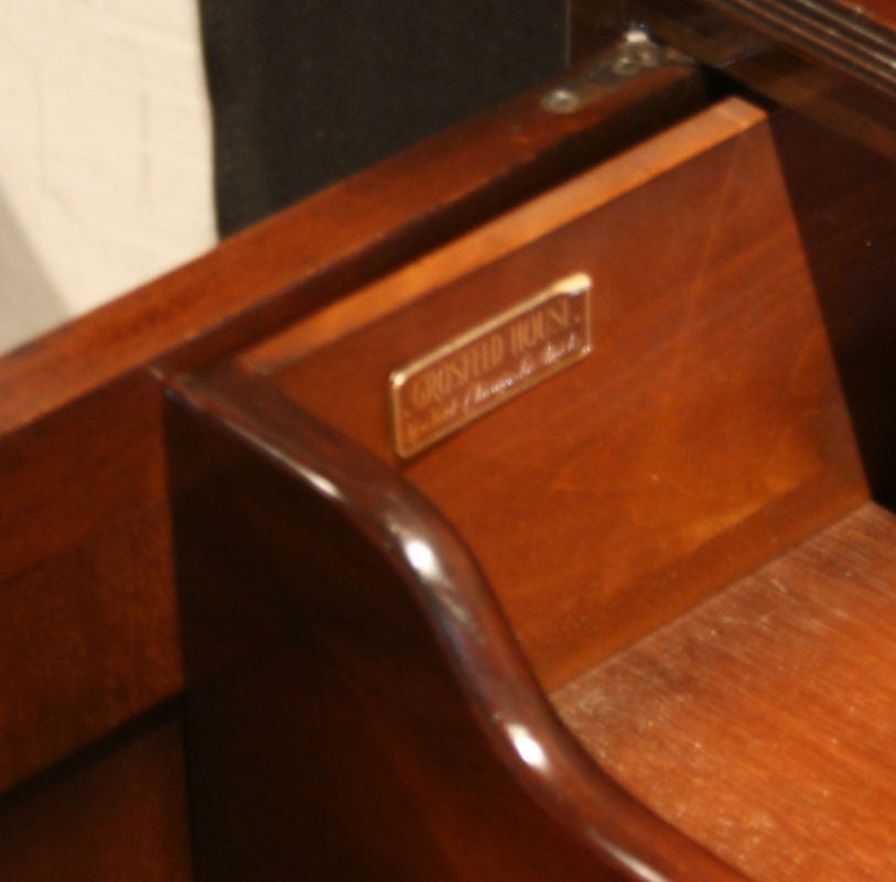 Grosfeld House Cabinet made from crotch mahogany veneer with very very impressive solid brass pulls, inside the cabinet has drawers, most likely for linens, and silverware originally.  Has an early Grosfeld House foil label.