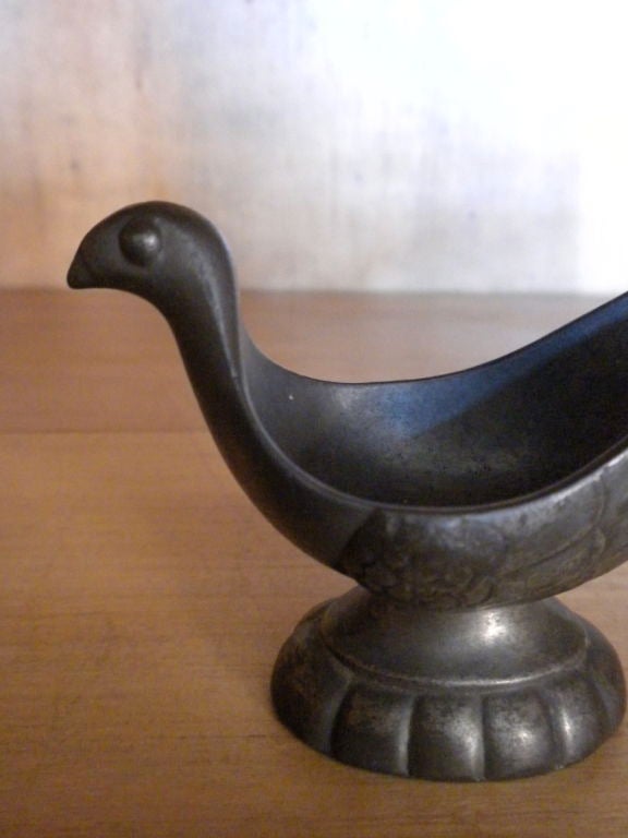 A small Just Andersen, 1884-1943, Denmark, pewter pipe holder in the form of a bird, Signed with monogram 'JUST'.