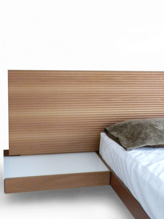A contemporary queen size platform bed, with integrated book shelves, side tables and light. This is the original 'Thai Bed' line from italydesign.com (which is now discontinued) and has the wonderful 
