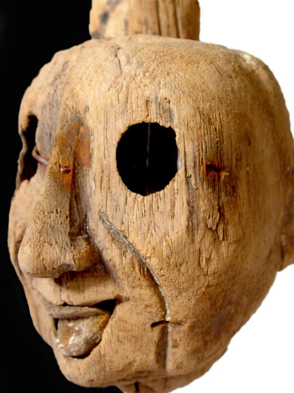 This is a very early and delicate wooden puppet head.  It could be Chinese but that's just a guess. I'll say it's late 1700's but could be a lot earlier. The mouth is a 2nd piece and is connected to the string. I love the weathered patina... The