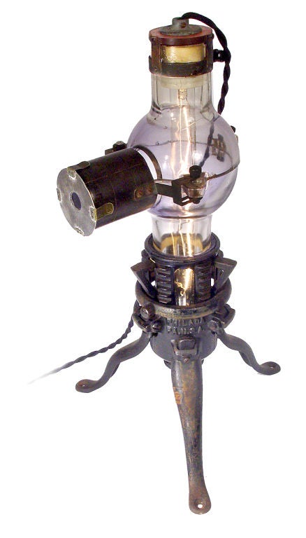 This one-of-a-kind lamp was created from a very early scientific X-Ray tube shield and fitted to a cast iron tripod base… It’s a perfect example of Steampunk style. Standing over 20