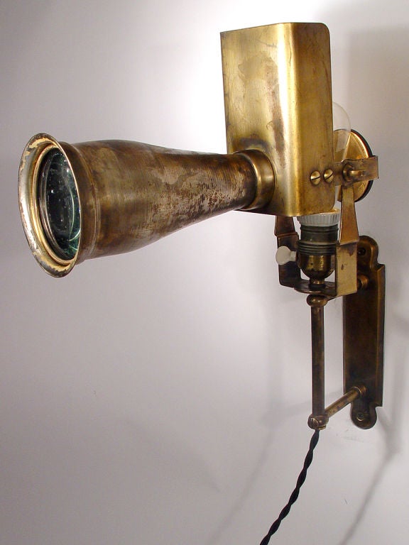 This is an early wall mounted and articulated long lens medical spot light. It's signed 
