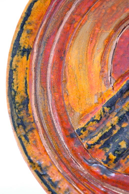 Beautifull orange, yellow and black glazed ceramic charger by Californian ceramist Kokko.Irregular hand thrown ceramic Signed and dated on reverse 