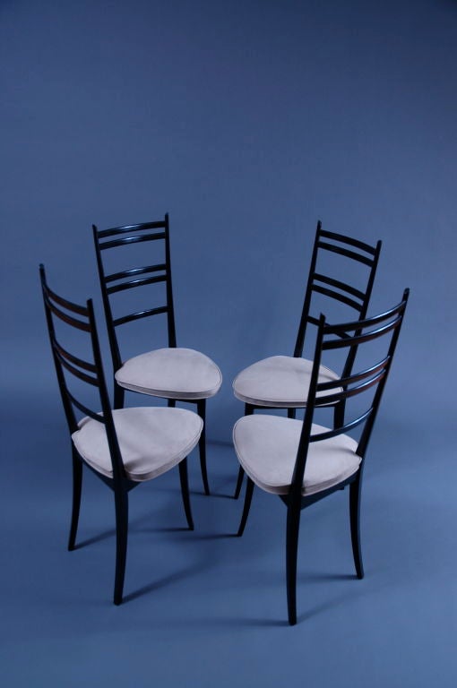Magnificent set of four 3 legged black lacquered  side chairs in the style of Gio Ponti. 

Newly refinished and upholstered with a grey ultra suede.