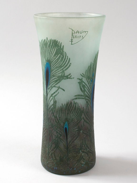 A French Art Nouveau cameo glass “Peacock” vase by Daum. The sea green vase is decorated with raised peacock feathers featuring striking two-toned blue centers. Signed, '' ''“Daum Nancy,” with the Croix de Lorraine.''. ''.