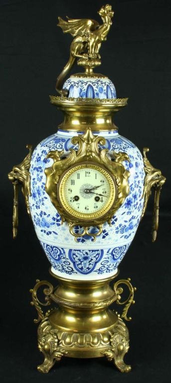 Rare three-piece, hand-painted Blue Delft Garniture Clock Set with brass dragon and lion ornamentation