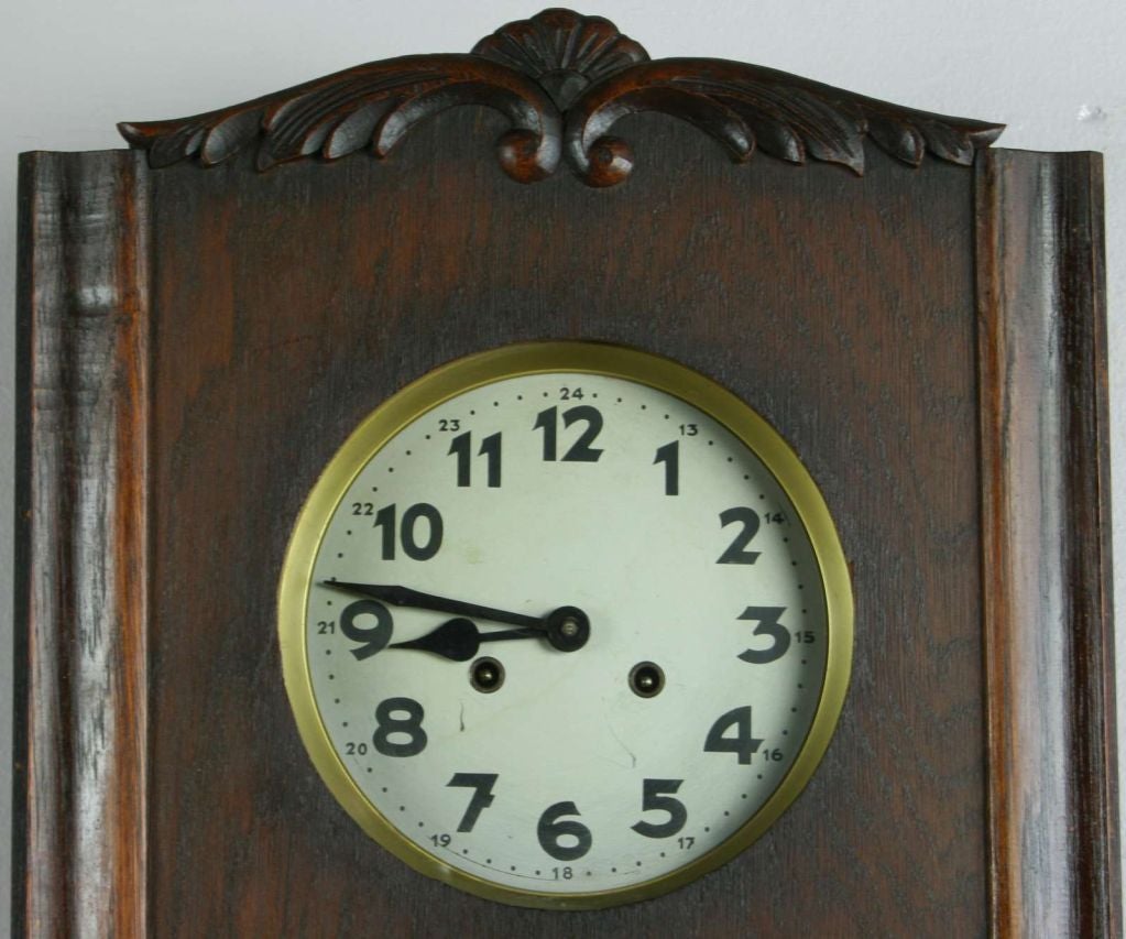 A German Art Deco Style Regulator Wall Clock with carved shell motif at top and leaded glass door