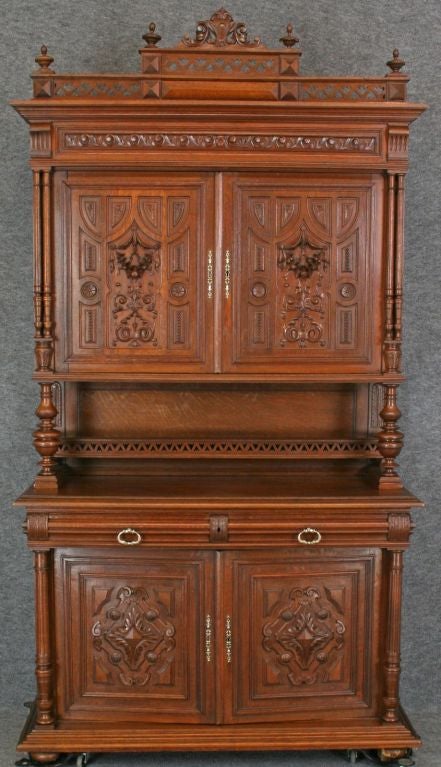 A French Henry II Renaissance Style Buffet Server Hutch in oak with four carved doors, two drawers, and a plate rack