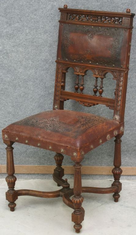 A set of 6 French Henry II Renaissance Style Dining Chairs with high-quality carved backs, turned legs and embossed leather seats