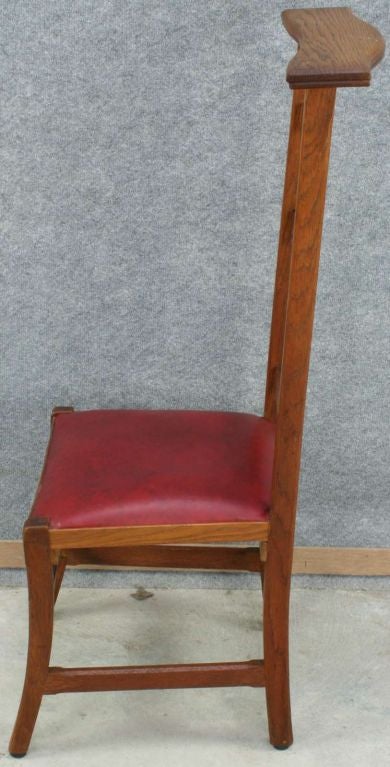 A French Prie Dieu Prayer Chair Kneeler in oak with a Gothic style carved cross on the back and upholstered seat