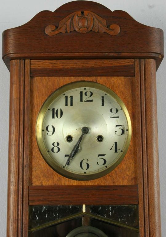 A German Art Deco Style Regulator Wall Clock in oak with original leaded glass door