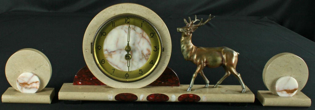 A three-piece French Art Deco garniture mantle clock set in marble with deer ornamentation