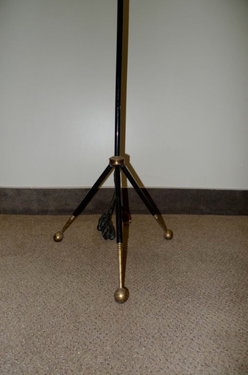 Elegant & whimsical tri-pod floor lamp from 1950's France with brass ball feet and fittings with lucite and enameled black metal. Diamond pattern parchment style plastic shade. Classic and distinctive design reminiscent of those of Jacques Adnet and