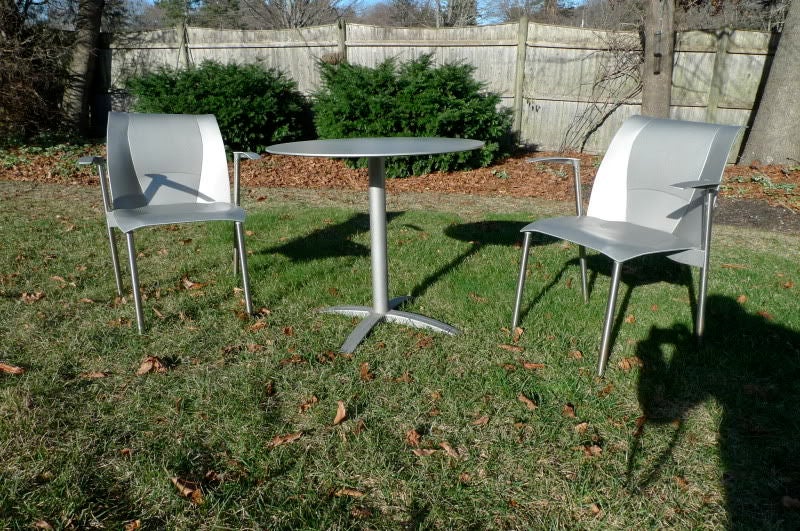 Cast aluminum pair of arm chairs and table, (perfect for the balcony of your high rise) designed in 1999 by Frank Gehry and produced by Knoll Studio.  Out of production. Hot specimen of architect designed furniture. Perfect for a high rise balcony