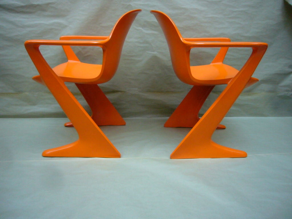 Pair of Orange Kangaroo Arm Chairs by Ernst Moeckl for Horn, Germany. Rare original color. Extremely sturdy and robust.