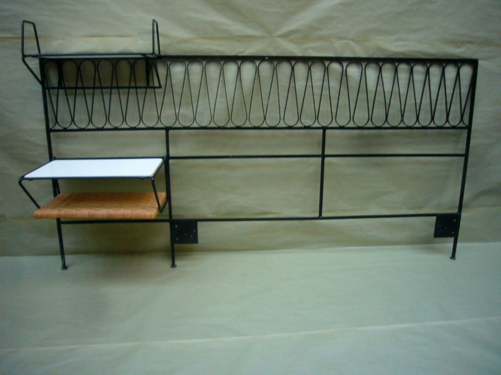 Mid-Century Iron headboard by Salterini with removable shelves.  Fits a Queen with shelves and a King without.<br />
<br />
The headboard is 75 and one quarter inches wide, and 38 inches high (with no shelves).<br />
<br />
The shelves take up
