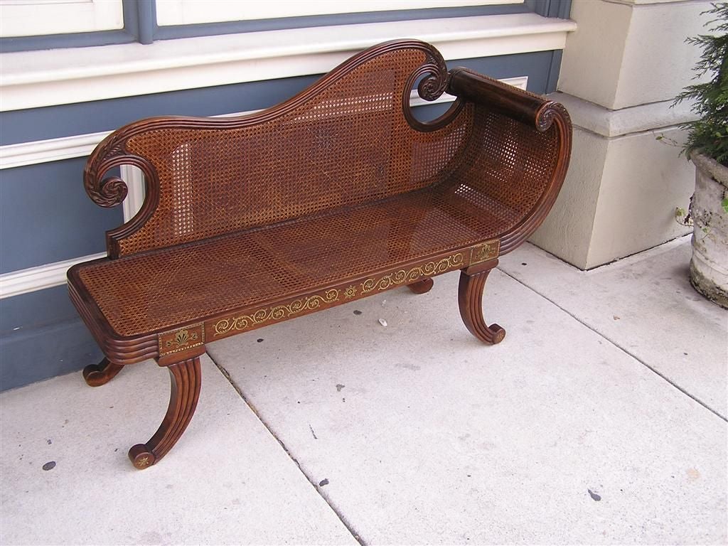 English Regency King wood recamier with carved scrolled acanthus back and arm, reeded molded edges, inlaid brass vine and shell motif, cane back & seat, and terminating on reeded scrolled legs.  Late 18th Century