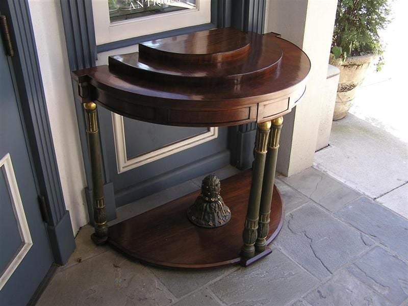 Italian mahogany & painted three tiered demi-lune console with a carved molded edge , stylized foliage motif urn, & terminating on gilt fluted bulbous legs. Late 18th Century. 