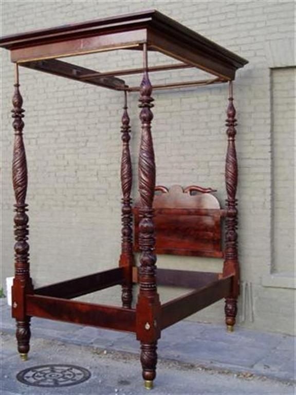 American mahogany Classical carved four poster bed with molded edge tester, flanking swan necks headboard, acanthus carved bulbous post, original rails, and terminating on brass cup feet.  Attributed to Anthony Quervelle, Philadelphia. Early 19th