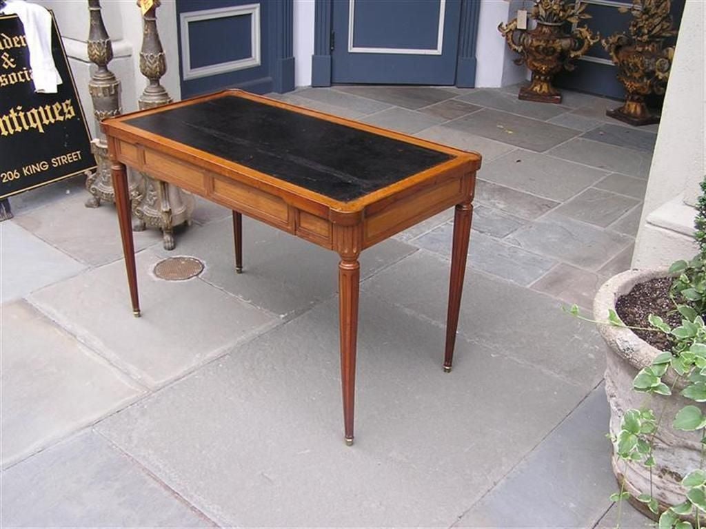 Italian mahogany Tric Trac Game Table. The table converts from a desk / card table to a backgammon table. The table has two flanking drawers terminating on fluted tapered legs with brass cup feet.  Early 19th Century. 