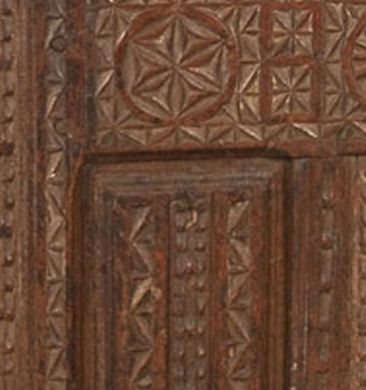 Spanish Baroque Period Carved Oak Coffer, Circa 1600-50; with a rectangular top over the chip carved front featuring geometric decoration raised on stile feet. The sides and back are paneled, and the interior has been later lined with cedar. 