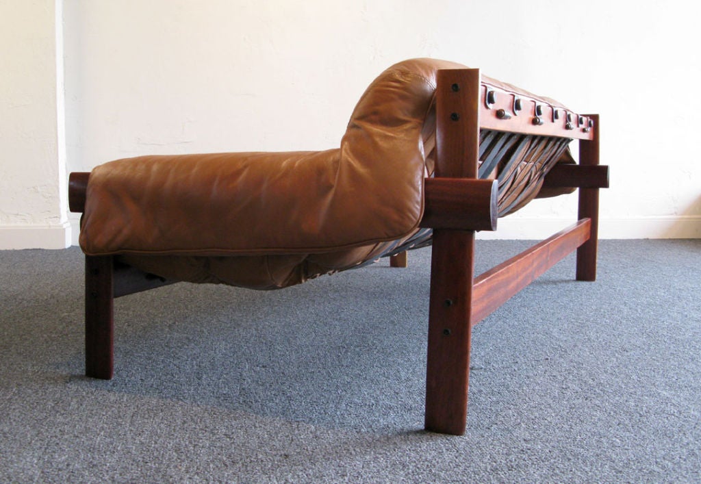 Organic Brazilian sofa designed by Percival Lafer in the early 1960's. Sofa has a solid Jacaranda Wood frame with leather straps and leather slung upholstered seat. Wood frame has been restored and the straps and seat is original. The leather