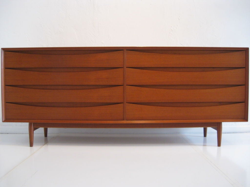Stunning and long dresser/buffet chest designed by Arne Vodder for Sibast Furniture. The design is sleek and simple and the condition is perfect. This is a very well constructed piece of solid teak. It was being used as a buffet but is also a