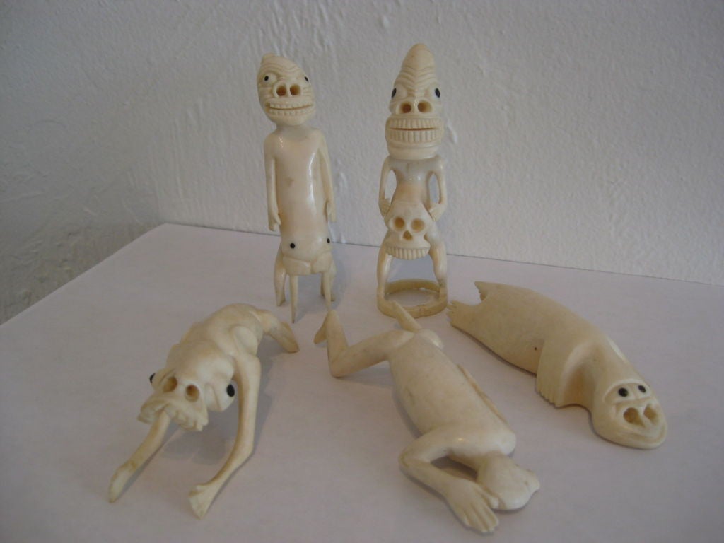Group of five carved Ivory Tupilak figures with extruded anthropomorphic features and inset baleen eyes. These were carved as souvenirs by the Inuit people of Greenland. They each measure around 4