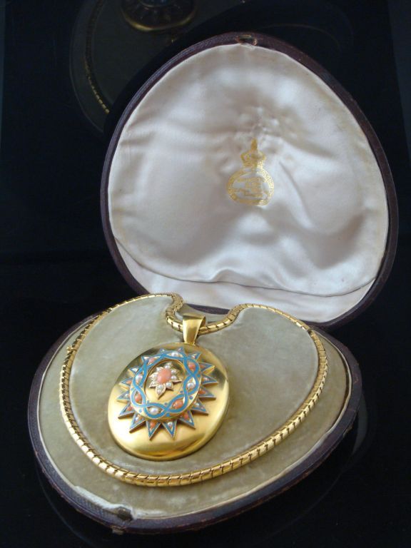 Oversized high carat gold locket on snake chain in fitted original box. <br />
Gold locket has elaborate turquoise and coral enamel design, with pearls. <br />
Chain measures approximately 16 1/2