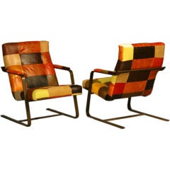 Leather patchwork pair of lounge chairs with bronze finish