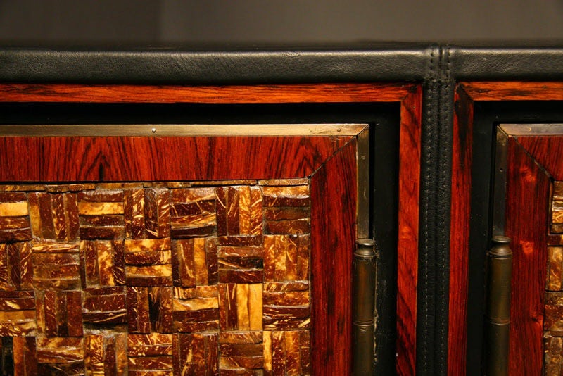 Leather clad buffet with bronze accents and coconut shell doors