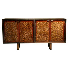 Leather clad buffet with bronze accents and coconut shell doors