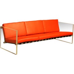 Solid lucite sofa with red leather cushions