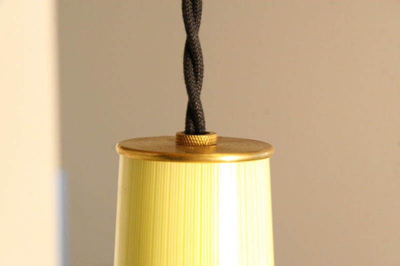 Set of three glass pendant lights in striped yellow and darker yellow with brass fitting on top and twisted black cords. Price below is for the set of 3.