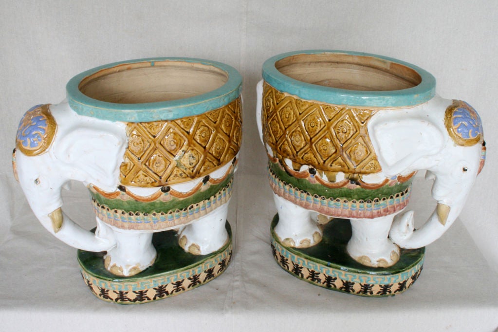 A large pair of glazed and paint decorated pottery planters.